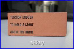 LAWRENCE WEINER, Tension enough to hold a stone above the rhine, Multiple